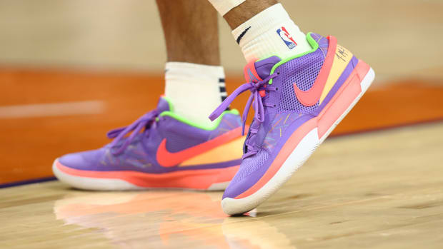 View of Ja Morant's purple and orange shoes.